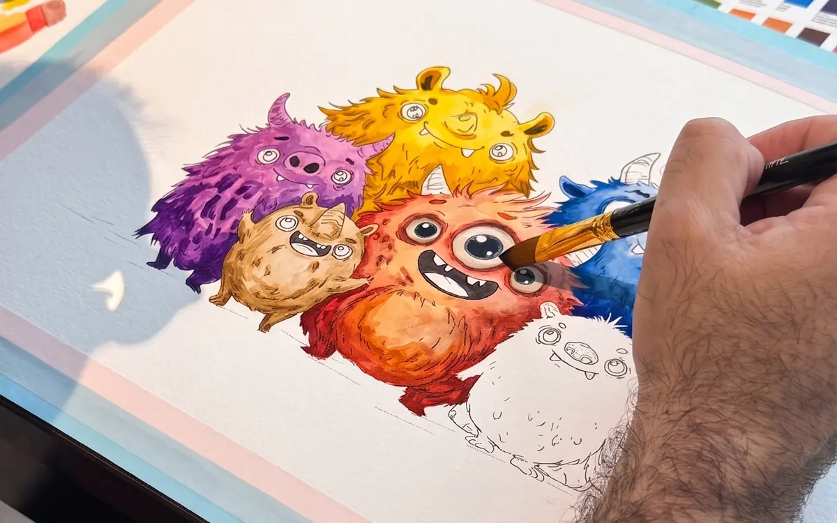 Pedro hand-painting a custom watercolor with a brush