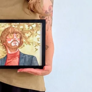 Client holding their finished personalised watercolour portrait, commission delivered