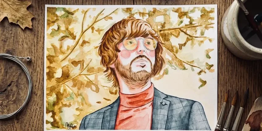 Watercolor portrait of Rufus next to painting materials, example of a custom commission
